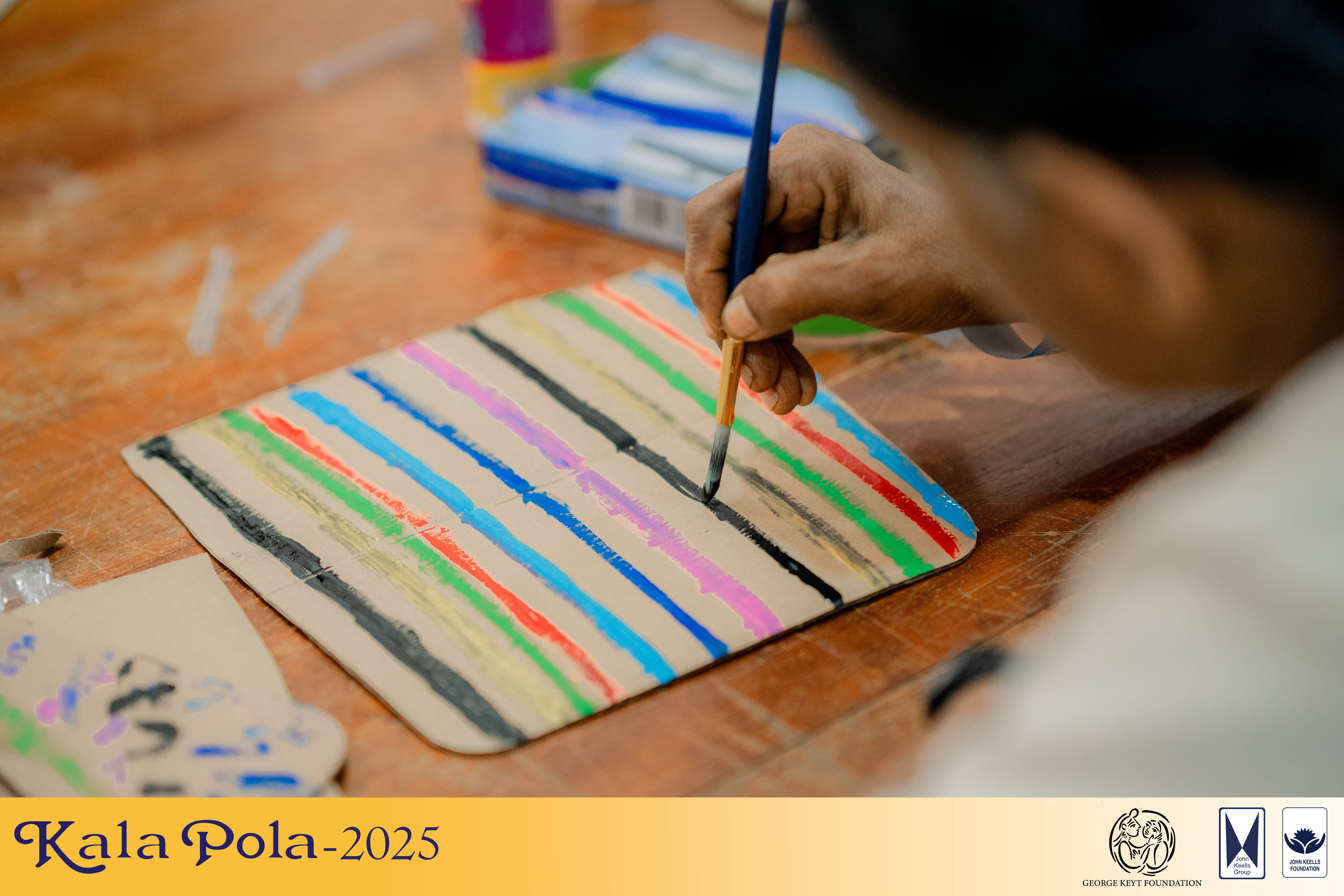 Two women engaged in painting together while seated at a table, showcasing creativity and collaboration.