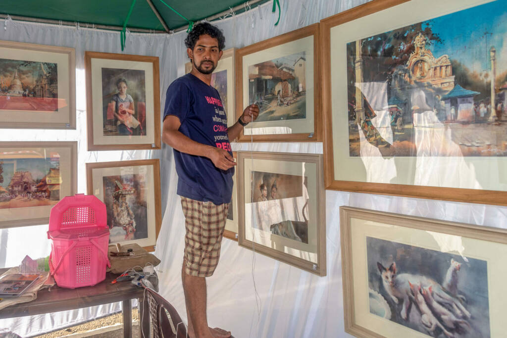 A collection of intricate metal sculptures showcased within a tent, highlighting artistic craftsmanship and creativity.
