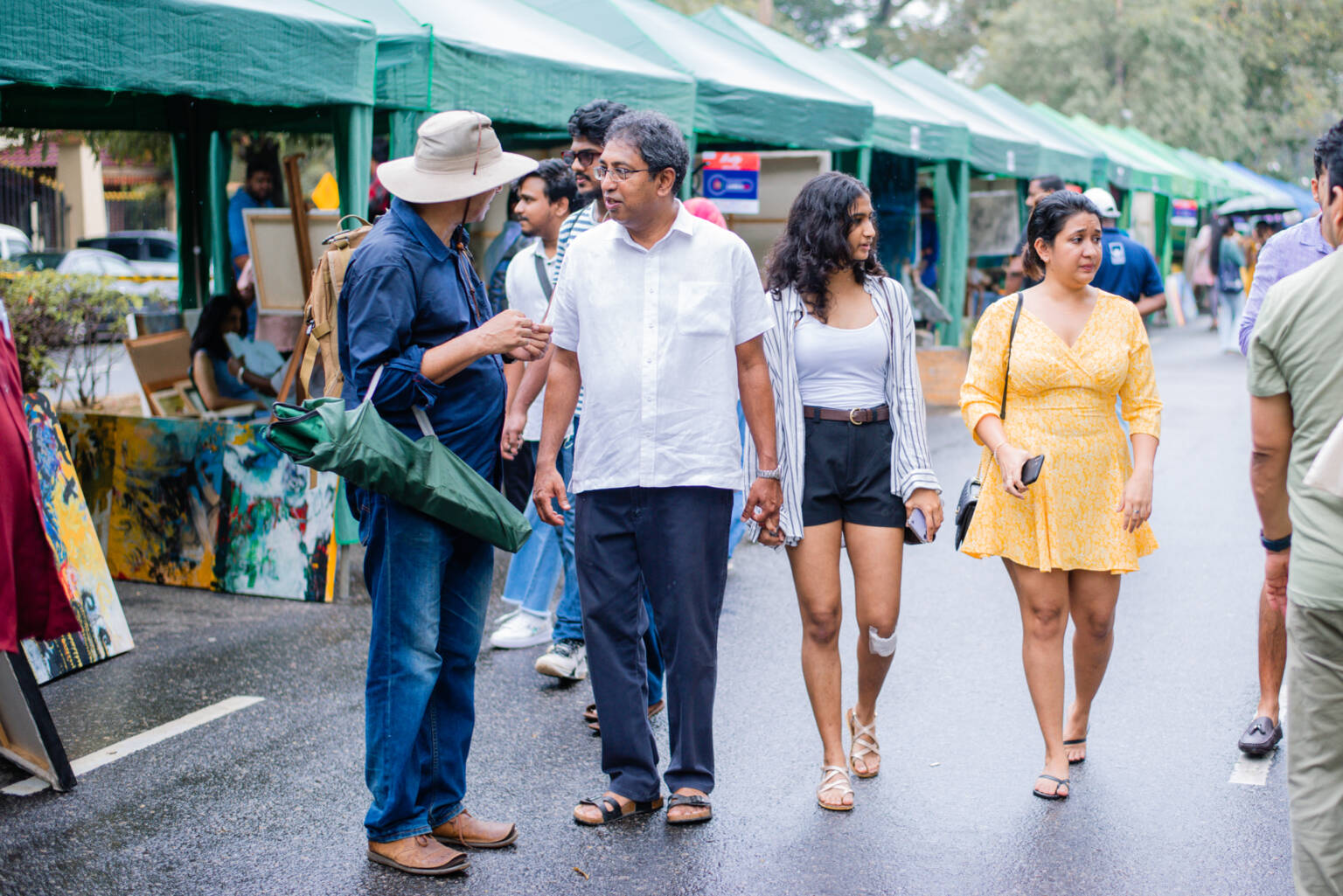 A group of people walking together on a street, engaged in conversation and enjoying each other's company.