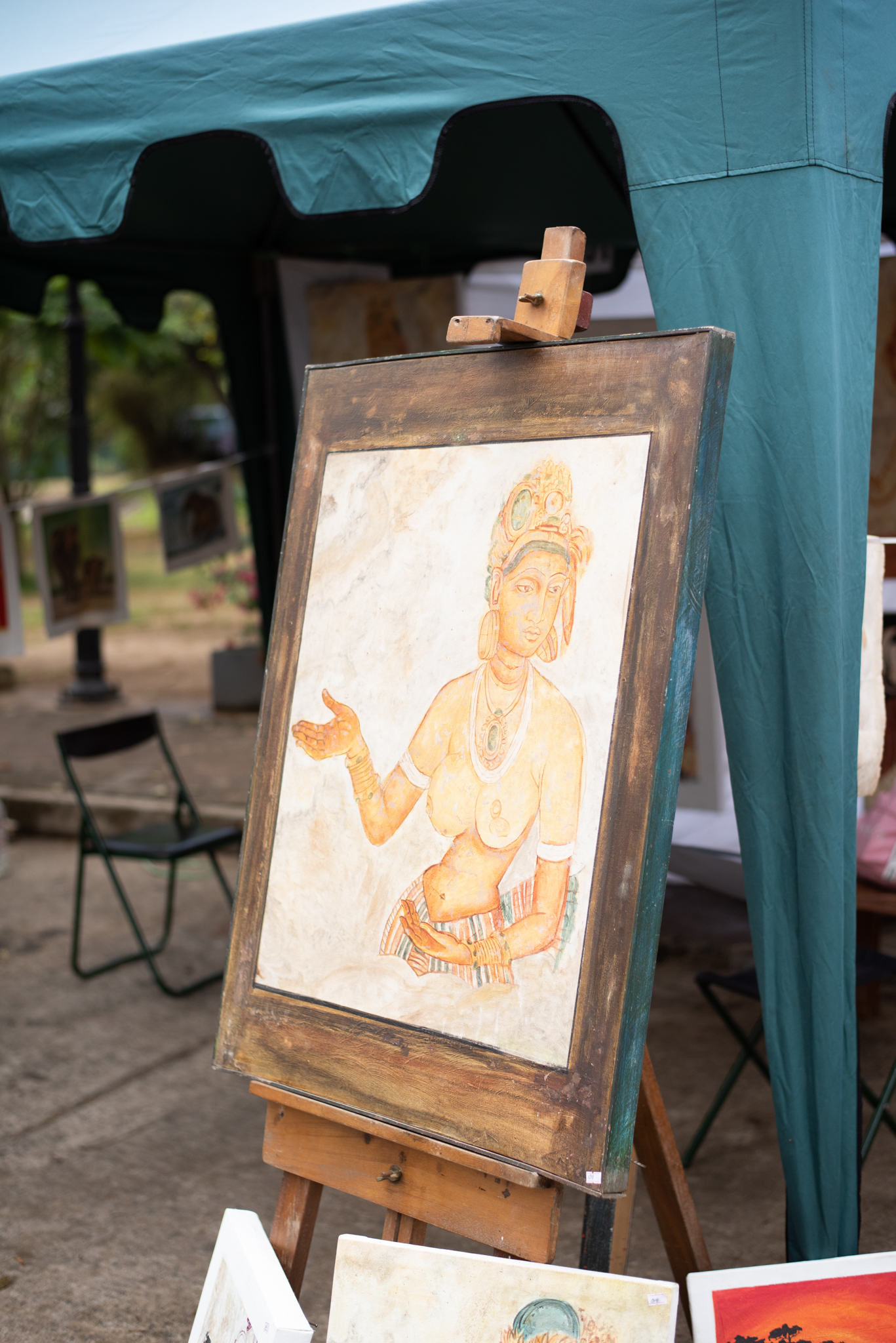 A diverse group of individuals gathered at an outdoor market, engaging in conversation and exploring various stalls.