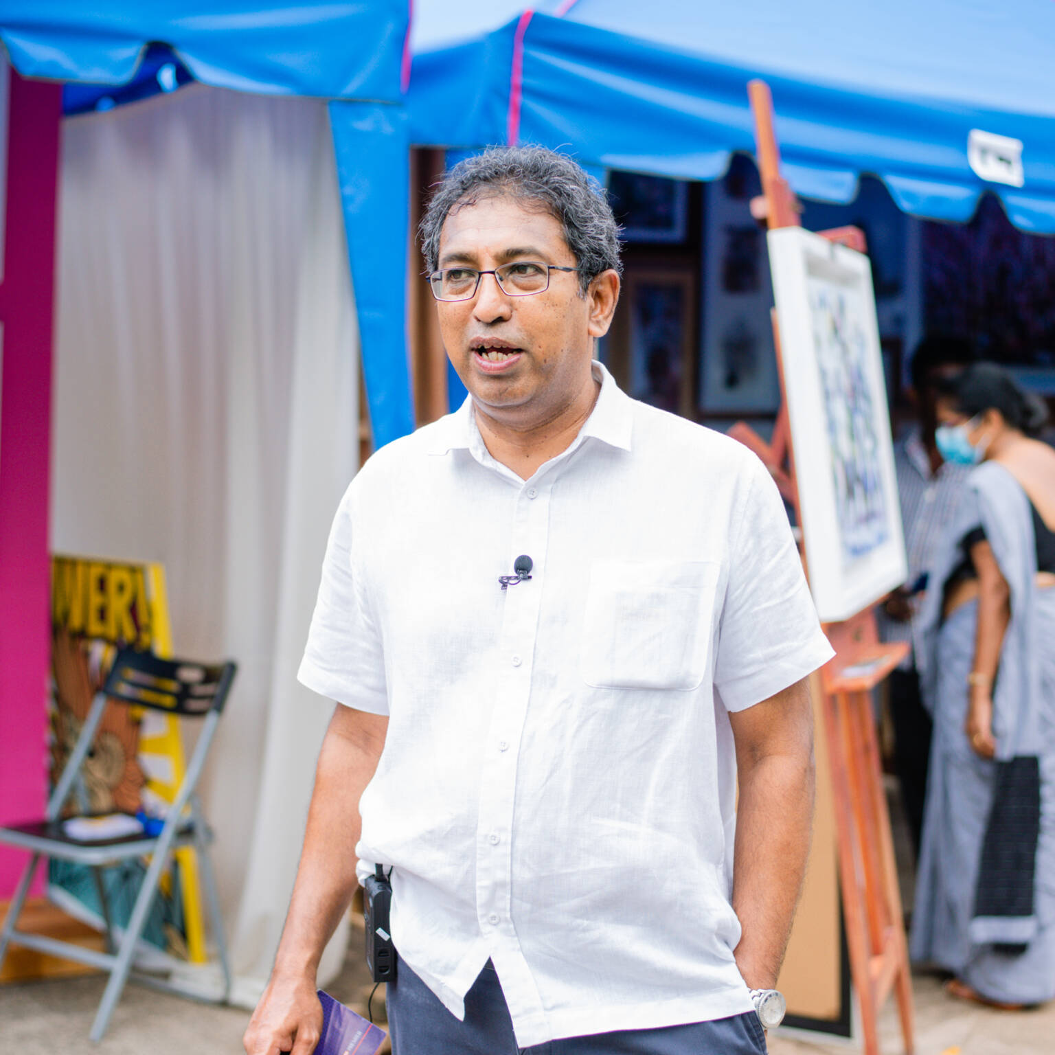 A painting on an easel depicting a serene scene reminiscent of Seegiri Apsarawan's artistic style.