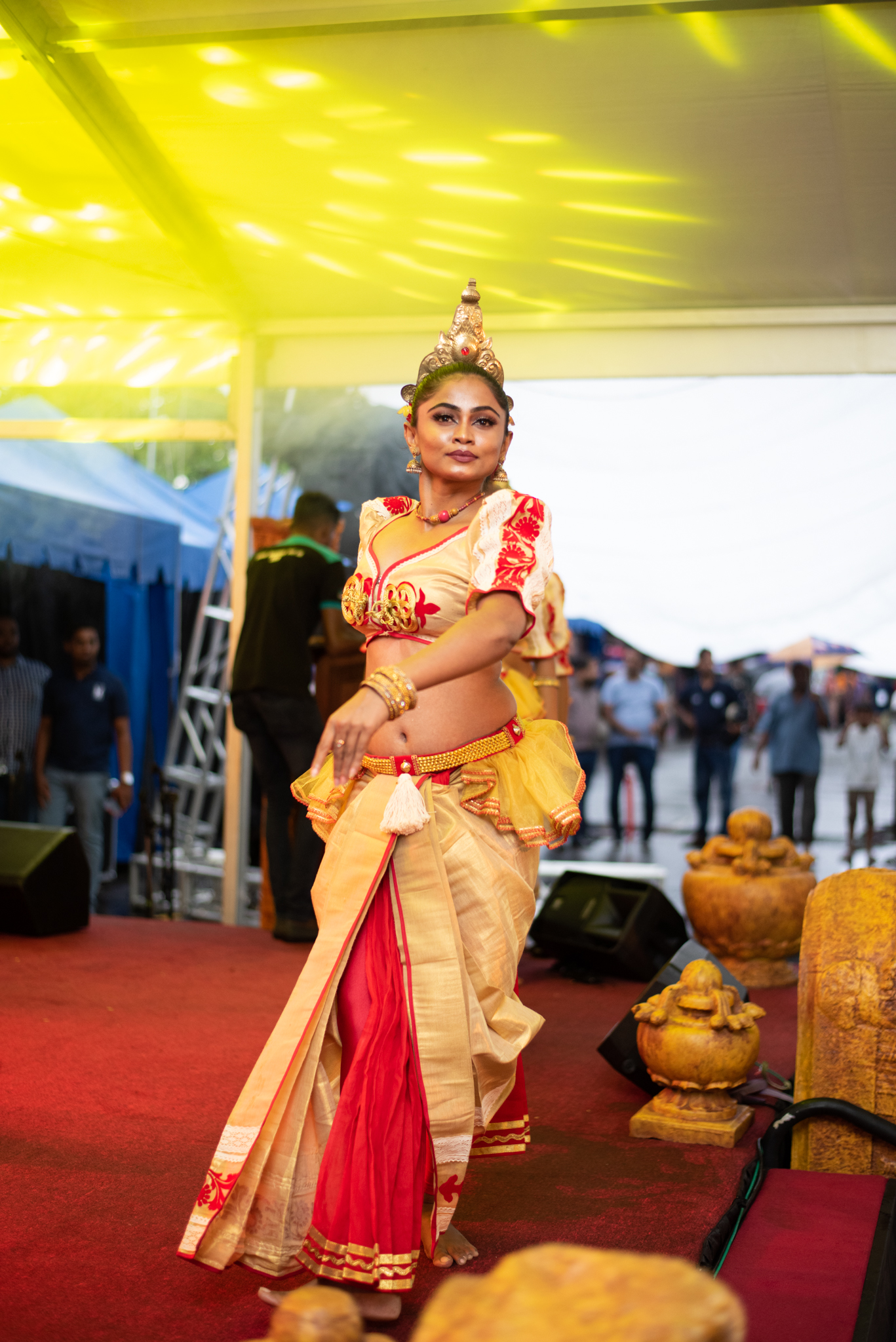 Traditional dancers in vibrant costumes perform on stage, captivating the audience with their rhythmic movements and grace.