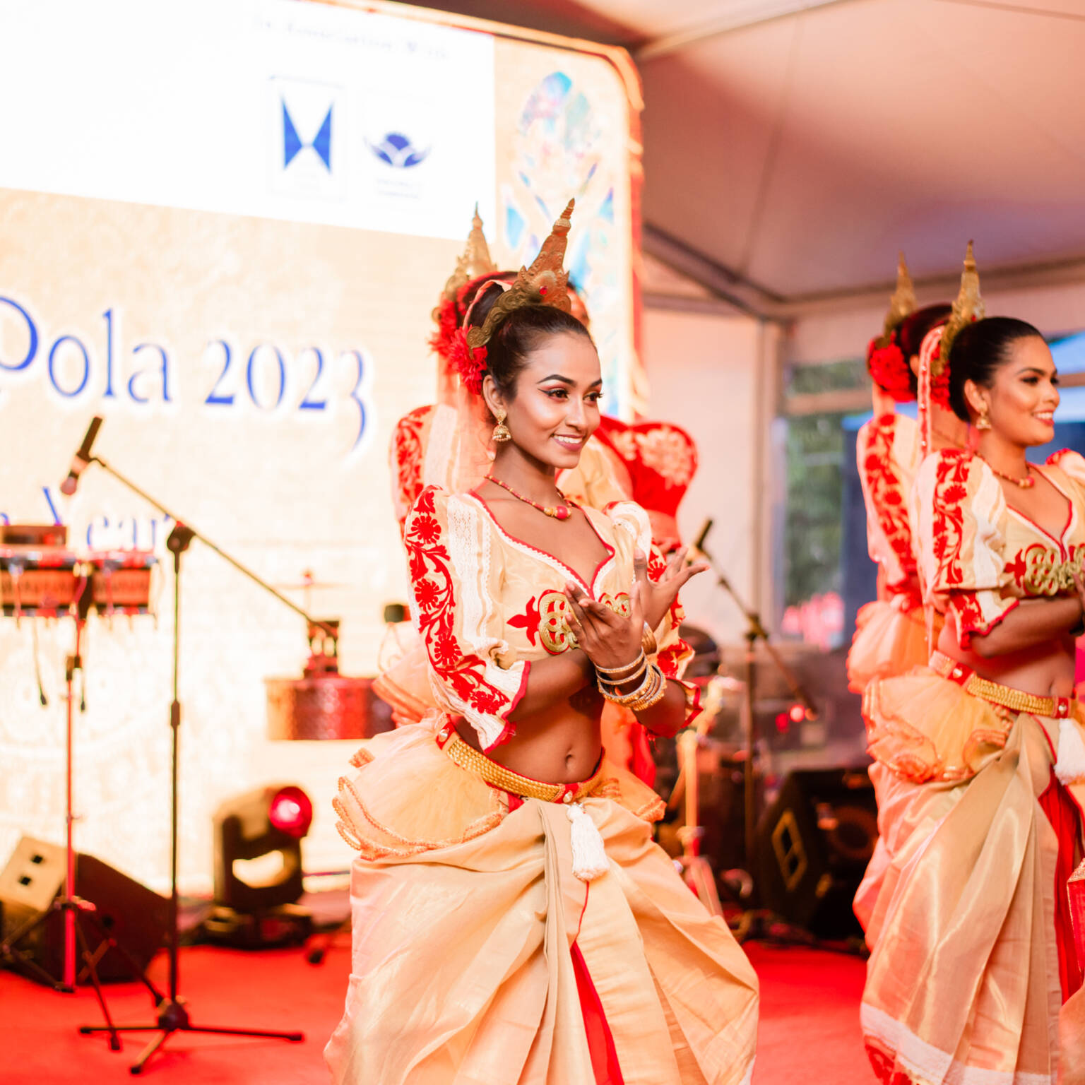 A vibrant gathering of people engaged in dance, expressing joy and camaraderie in a festive setting.
