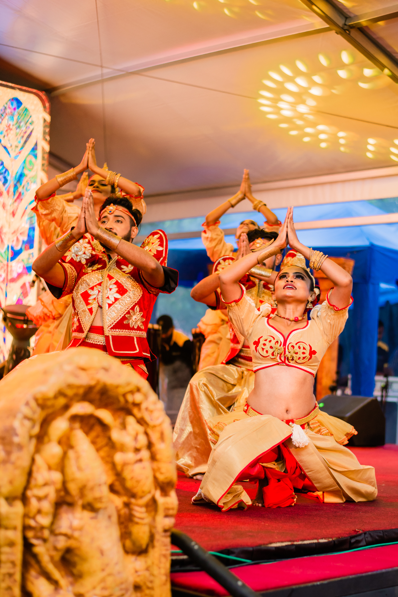 A woman in a vibrant costume gracefully dances, showcasing her movements and the intricate details of her attire.
