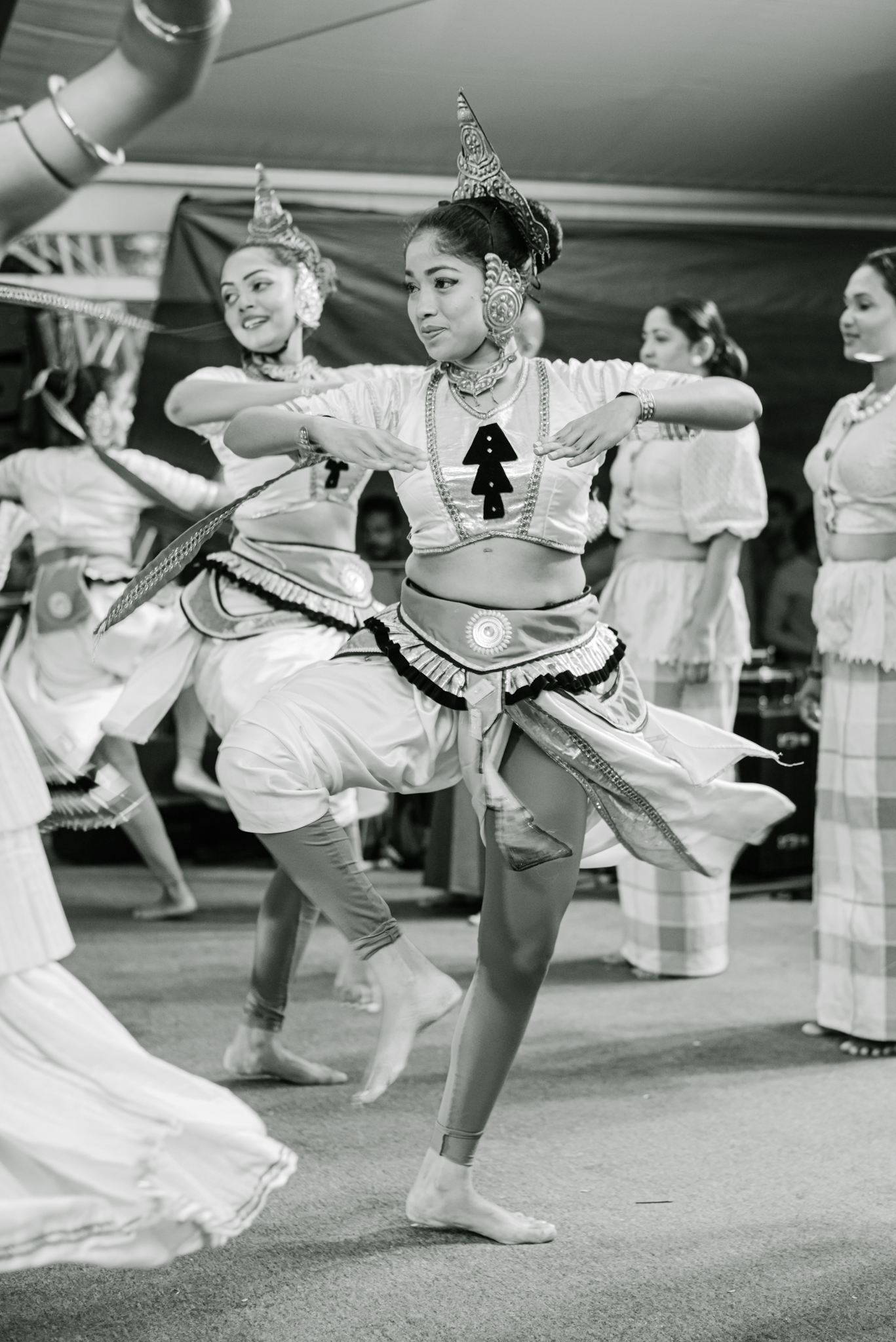 A woman in a flowing white dress gracefully dances, embodying elegance and joy in her movements.